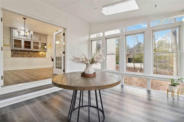 sunroom with lofted ceiling with skylight, french doors, and ceiling fan