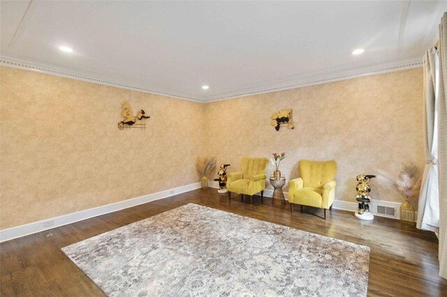 sitting room featuring dark wood-type flooring and ornamental molding