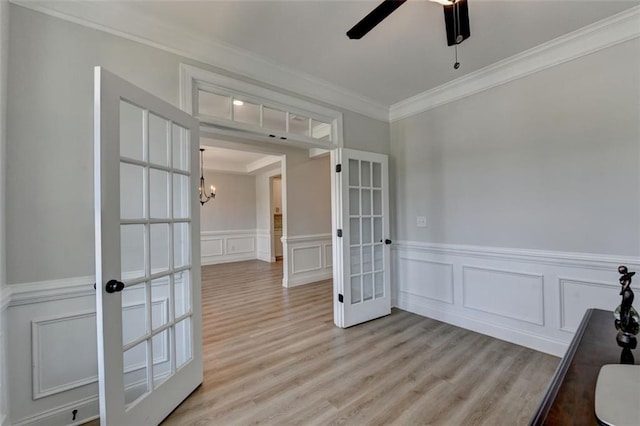 6867 Kate Ln, Flowery Branch, GA 30542 - spare room with french doors, ornamental molding, a decorative wall, a ceiling fan, and a chandelier