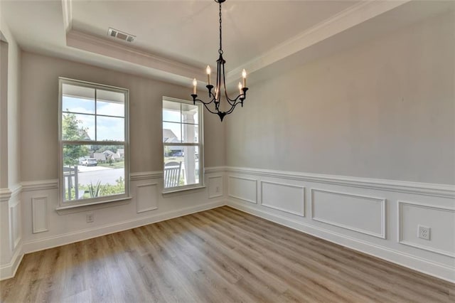 6867 Kate Ln, Flowery Branch, GA 30542 - unfurnished room with a chandelier, ornamental molding, light wood-type flooring, a wainscoted wall, and a decorative wall