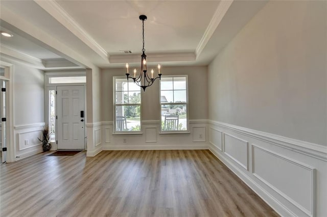 6867 Kate Ln, Flowery Branch, GA 30542 - foyer featuring a tray ceiling, a chandelier, wood finished floors, a wainscoted wall, and crown molding