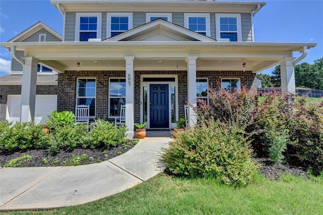 6867 Kate Ln, Flowery Branch, GA 30542 - view of front of home with brick siding and covered porch
