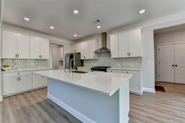 6867 Kate Ln, Flowery Branch, GA 30542 - kitchen featuring wall chimney range hood, gas range oven, light countertops, decorative backsplash, and ornamental molding