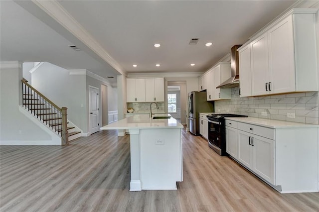 6867 Kate Ln, Flowery Branch, GA 30542 - kitchen featuring electric stove, ornamental molding, wall chimney range hood, freestanding refrigerator, and light wood-type flooring