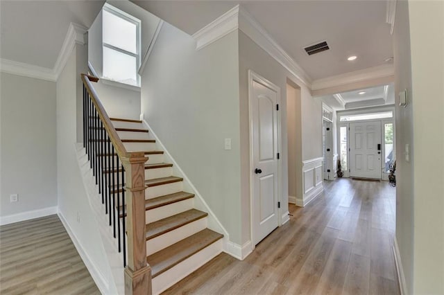 6867 Kate Ln, Flowery Branch, GA 30542 - entrance foyer featuring ornamental molding, light wood finished floors, stairs, and recessed lighting