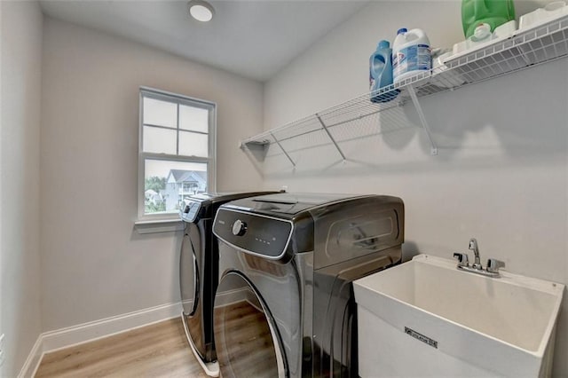 6867 Kate Ln, Flowery Branch, GA 30542 - laundry area with washer and dryer and light wood-style floors