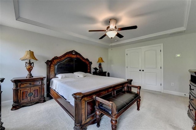 6867 Kate Ln, Flowery Branch, GA 30542 - bedroom with a raised ceiling, light carpet, ceiling fan, a closet, and crown molding