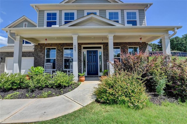 6867 Kate Ln, Flowery Branch, GA 30542 - view of front facade with brick siding and covered porch