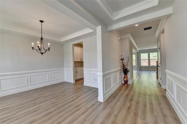 6867 Kate Ln, Flowery Branch, GA 30542 - hall with a raised ceiling, a decorative wall, light wood-style flooring, crown molding, and a chandelier