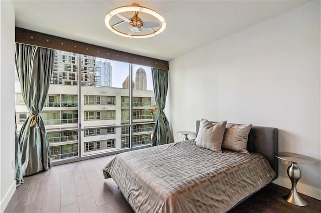 20 10th St NW Unit 704, Atlanta, GA 30309 - bedroom featuring a wall of windows, a city view, and wood finished floors