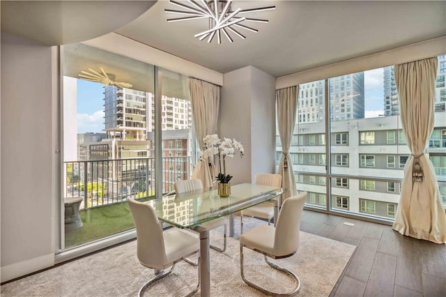 20 10th St NW Unit 704, Atlanta, GA 30309 - dining area featuring floor to ceiling windows, a view of city, plenty of natural light, hardwood / wood-style floors, and a chandelier