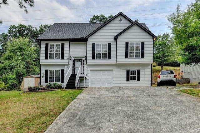 split foyer home featuring a front yard and a garage