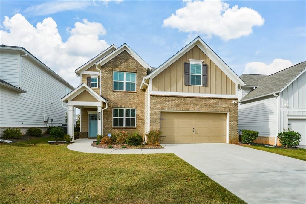 craftsman-style home with a garage and a front yard