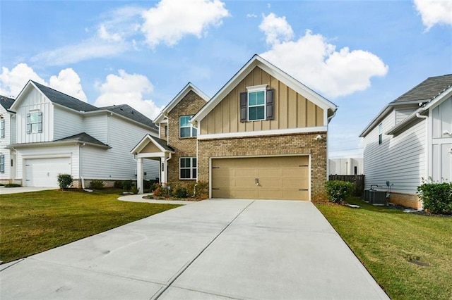 view of front of house featuring a garage, a front yard, and central air condition unit