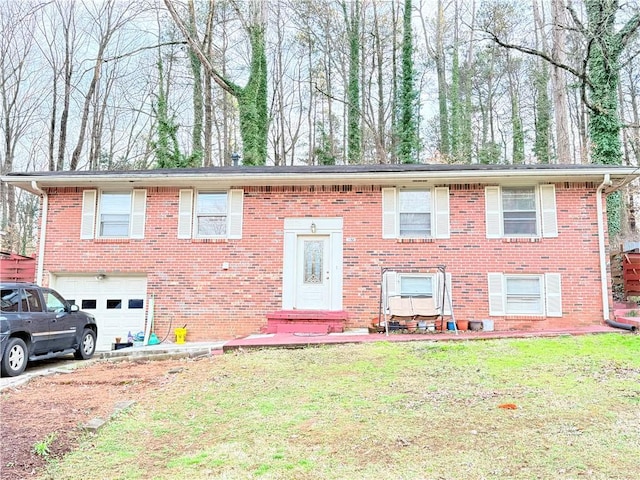 bi-level home with brick siding, a front yard, and a garage