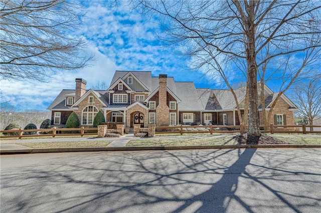 view of front of home featuring a fenced front yard and a chimney