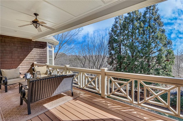 wooden terrace featuring outdoor lounge area and ceiling fan