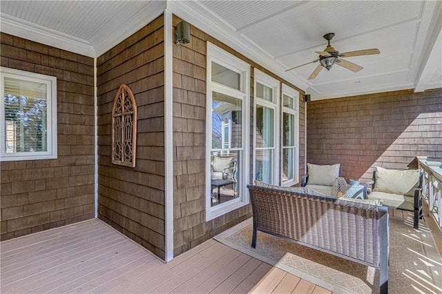 wooden deck with a porch and a ceiling fan