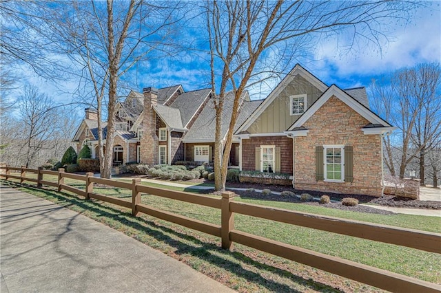 view of front of house with a fenced front yard, board and batten siding, and a front yard