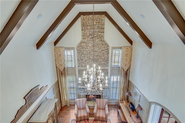 interior space featuring a healthy amount of sunlight, high vaulted ceiling, and beamed ceiling