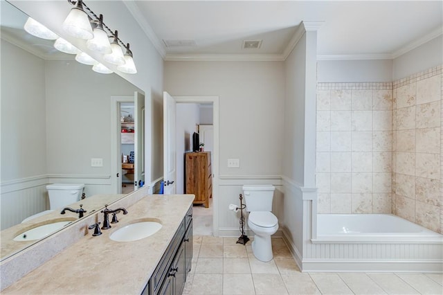 bathroom with toilet, tile patterned flooring, visible vents, and wainscoting