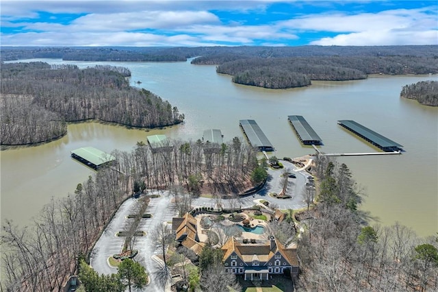 aerial view with a water view and a forest view