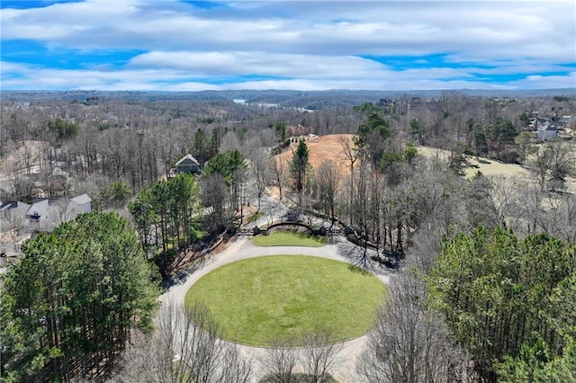 drone / aerial view featuring a wooded view