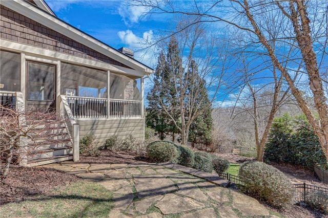 exterior space with a sunroom and stairway