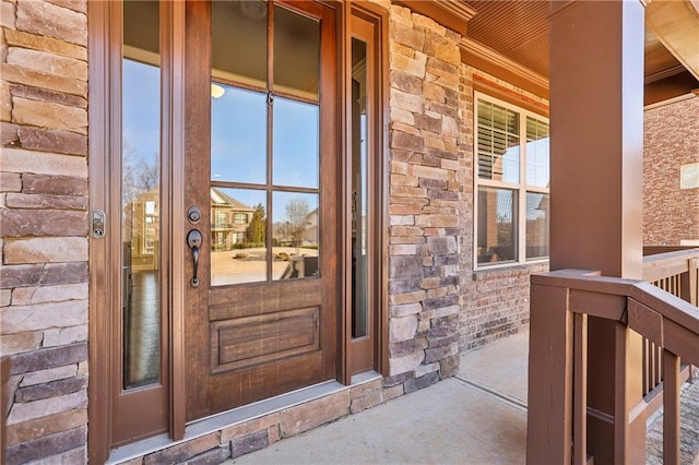 doorway to property featuring stone siding