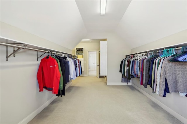 spacious closet featuring carpet floors and vaulted ceiling