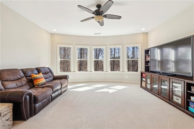 living area with light carpet, ceiling fan, baseboards, and recessed lighting