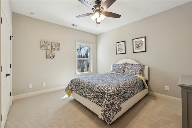 bedroom with baseboards, visible vents, a ceiling fan, and light colored carpet