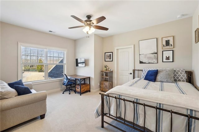 bedroom with a ceiling fan, light colored carpet, visible vents, and baseboards