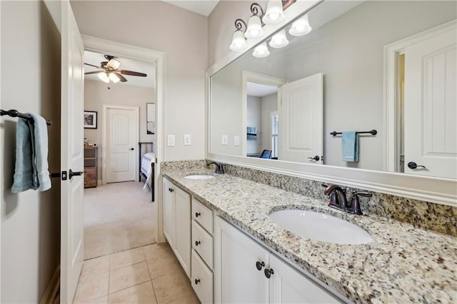 full bath featuring double vanity, ceiling fan, a sink, and tile patterned floors