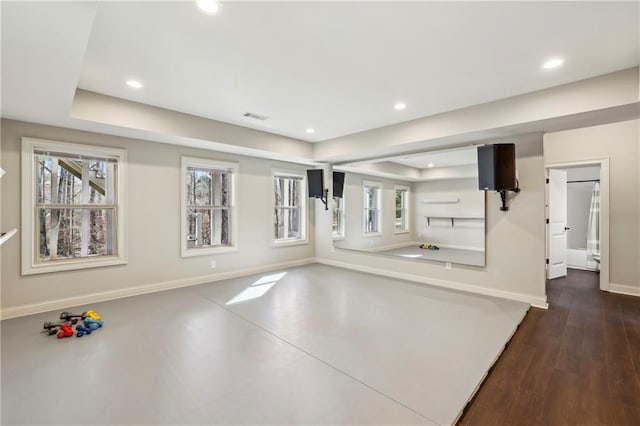 workout area featuring recessed lighting, a tray ceiling, visible vents, and baseboards