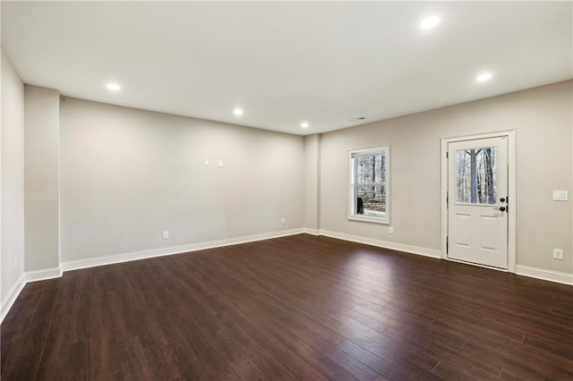 interior space with baseboards, dark wood-type flooring, and recessed lighting