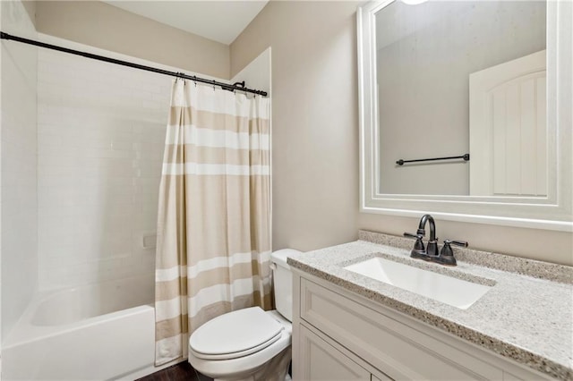 bathroom with shower / tub combo, vanity, and toilet