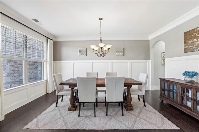 dining room featuring arched walkways, visible vents, dark wood finished floors, and an inviting chandelier