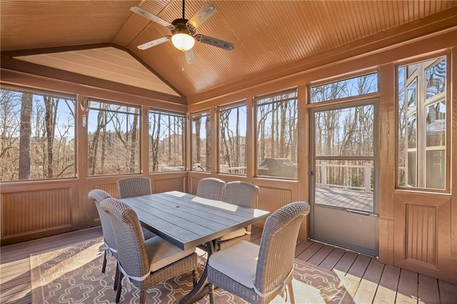 sunroom with plenty of natural light, wood ceiling, vaulted ceiling, and ceiling fan