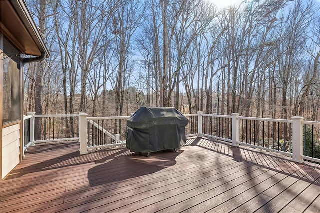 wooden terrace with a grill