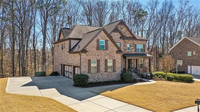 view of front facade with a garage, driveway, brick siding, and a front lawn