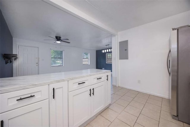 4618 Conner Rd, Columbus, GA 31903 - kitchen with freestanding refrigerator, electric panel, white cabinetry, ceiling fan, and light stone countertops