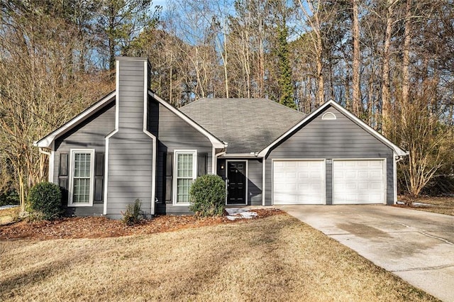 view of front of house featuring a front yard and a garage