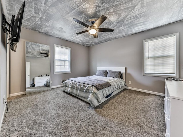 bedroom with baseboards, carpet floors, a textured ceiling, and a ceiling fan