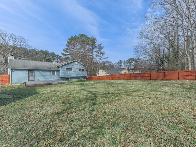 view of yard featuring a wooden deck and fence