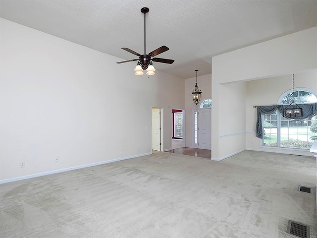 5 Glenn Eagles Vw, Hiram, GA 30141 - unfurnished living room featuring a chandelier, carpet, healthy amount of natural light, a towering ceiling, and a ceiling fan