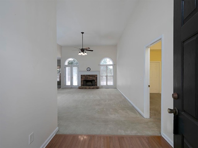 5 Glenn Eagles Vw, Hiram, GA 30141 - unfurnished living room with a ceiling fan, carpet flooring, a fireplace, high vaulted ceiling, and wood finished floors