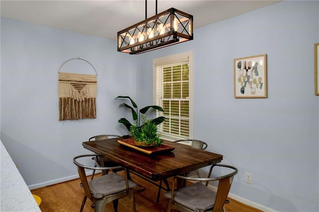 1445 Monroe Dr NE Unit C13, Atlanta, GA 30324 - dining area with baseboards, wood finished floors, and a chandelier