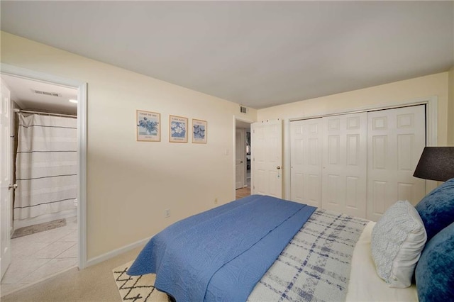 1445 Monroe Dr NE Unit C13, Atlanta, GA 30324 - bedroom with baseboards, ensuite bath, light carpet, and a closet