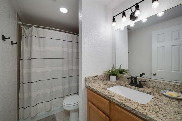 1445 Monroe Dr NE Unit C13, Atlanta, GA 30324 - bathroom featuring vanity, toilet, a textured wall, tile patterned floors, and recessed lighting